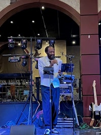 a man in a suit standing in front of a microphone