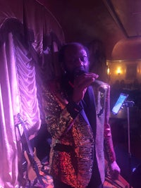 a man in a suit singing into a microphone