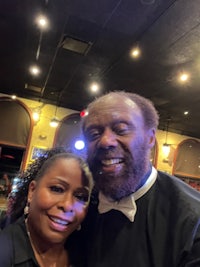 a man and woman posing for a photo in a restaurant