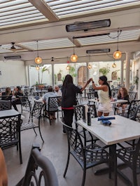 a group of people sitting at tables in a restaurant