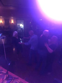 a group of people dancing at a party